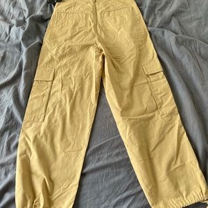 Small, beige cargo style joggers.